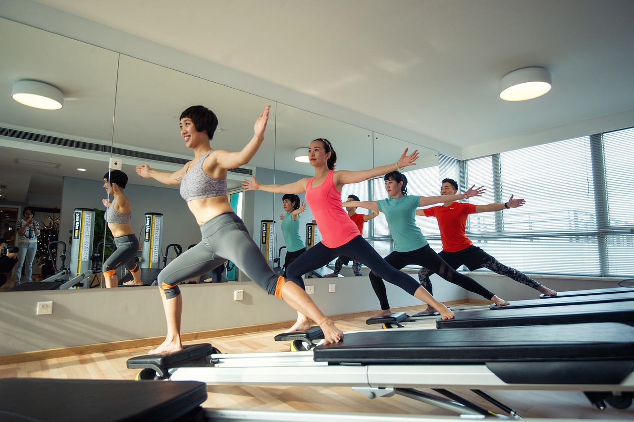 Women working out on a reformer Pilates machine at Misfit PT & Fitness